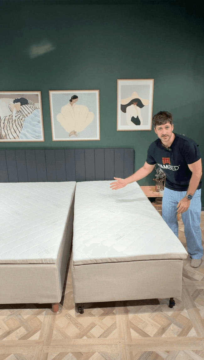 A man demonstrates the wheeled extension bed, rolled right up against the existing bed