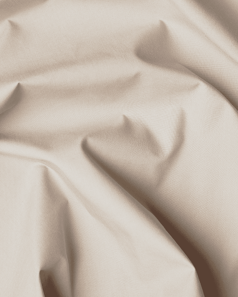 Primer plano del algodón beige con certificación OEKO-TEX® utilizado para confeccionar el faldón de cama