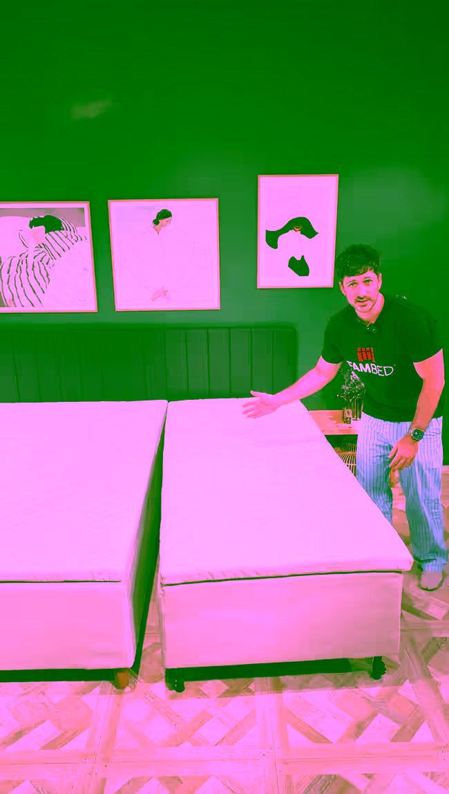 A man demonstrates the wheeled extension bed, rolled right up against the existing bed